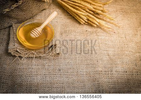 cup honey on sackcloth Vintage Style and selective focus