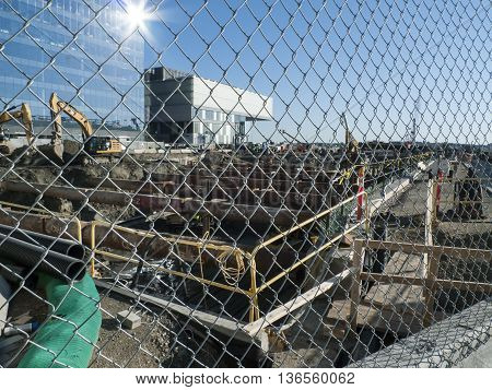 Boston Massachusetts USA - June 30 2016: Temporary two-foot diameter pipes being installed to brace foundation walls during construction on Pier 4 project in South Boston