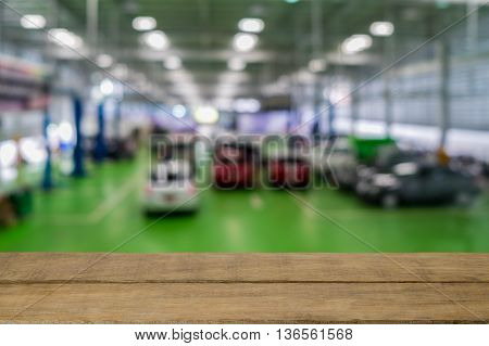 Garage blurred background with empty wooden top table. For product display