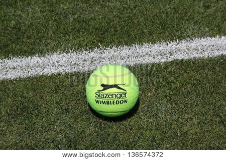 NEW YORK - JUNE 30, 2016: Slazenger Wimbledon Tennis Ball on grass tennis court. Slazenger Wimbledon Tennis Ball exclusively used and endorsed by The Championships, Wimbledon