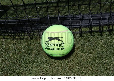 NEW YORK - JUNE 30, 2016: Slazenger Wimbledon Tennis Ball on grass tennis court. Slazenger Wimbledon Tennis Ball exclusively used and endorsed by The Championships, Wimbledon