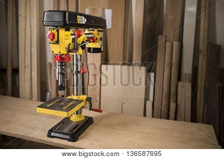Vertical drilling machine on table with tools