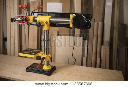 Vertical drilling machine on table with tools