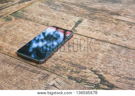 Moblie smart phone on wood table background