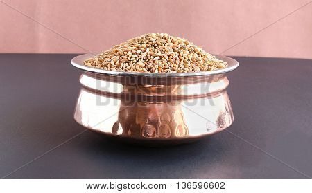 Bamboo rice, which is said to be an alternative medicine for health issues like cough and asthma, in a copper bowl.