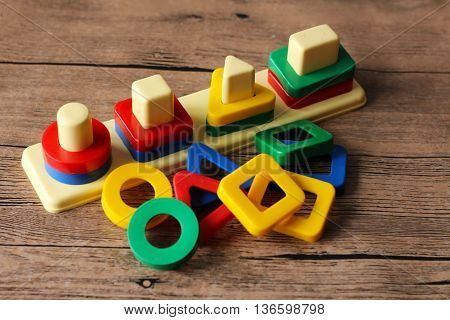 colored geometric forms on wooden table, toys.