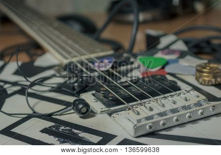 The electric guitar with headphones and mediators