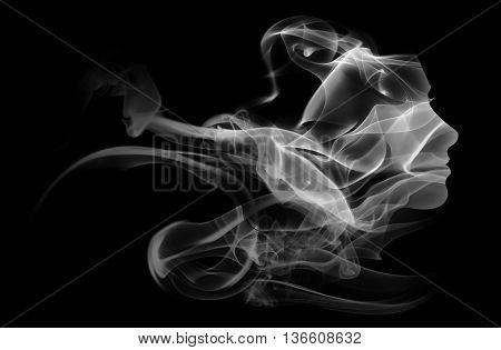Double exposure portrait of young woman and cigarette smoke isolated on black