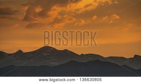 silhouette of Front Range of Rocky Mountains against sunset sky, Longmont, Colorado