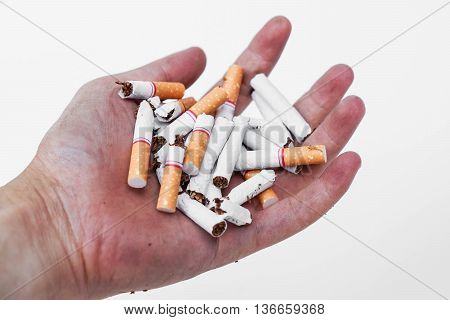 Stop smoking - Hand of a smoker holding destroyed cigarettes - World no tobacco day concept