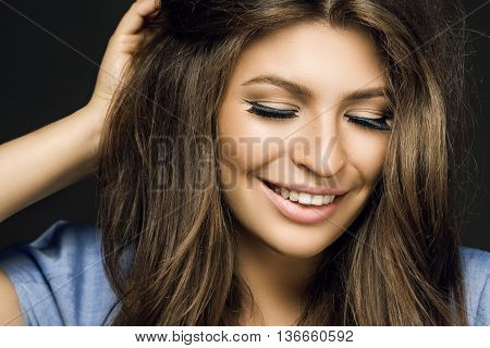 Happy Pretty Girl Smiling On A Black Background. A Large Portrait Of A Woman With Long Hair And Make