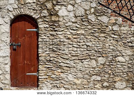 Single Wooden Door in Old City Wall. Ukraine Dubno Carpathian