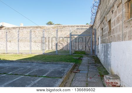 FREMANTLE,WA,AUSTRALIA-JUNE 1,2016:  Gated isolate yard at the Fremantle Prison under a clear blue sky in Fremantle, Western Australia.