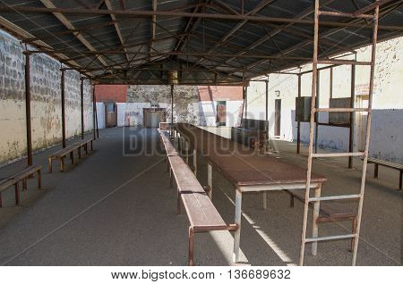 FREMANTLE,WA,AUSTRALIA-JUNE 1,2016:  Outdoor yard at the Fremantle Prison with tables and benches in Fremantle, Western Australia.