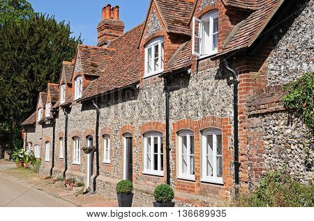 Pretty brick and flint cottages with dormer windows along a village street Hambledon Oxfordshire England UK Western Europe.