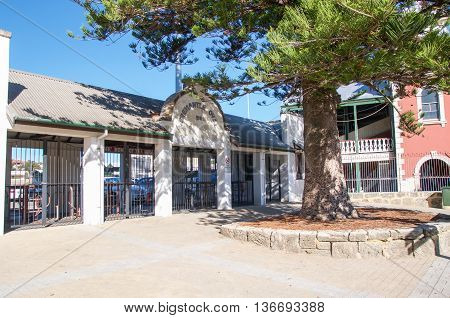 FREMANTLE,WA,AUSTRALIA-JUNE 1,2016: Fremantle Oval sports ticket booth with Norfolk Pine in Fremantle, Western Australia.