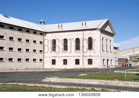 FREMANTLE,WA,AUSTRALIA-JUNE 13,2016: The Fremantle Prison with arched windows and limestone architecture under a blue sky in Fremantle, Western Australia.