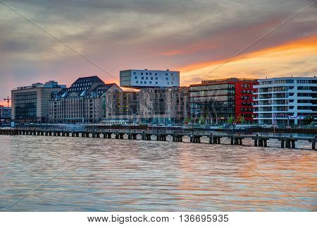 Sunset at the river Spree in Berlin with modern office buildings at the riverbank