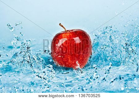 image of fresh water splash on red apple