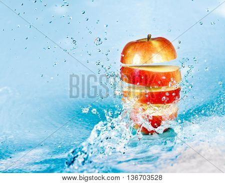 image of fresh water splash on red apple