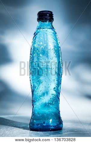 Image of bottle of water on blue background