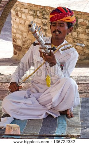 Indian Musician In Traditional Dress Playing Musical Instruments