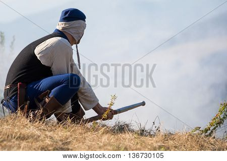 Person with historical firearm in shooting practice