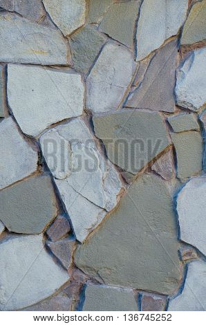 Background of a stone wall cladding texture brown stone bricks