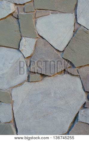 Background of a stone wall cladding texture brown stone bricks