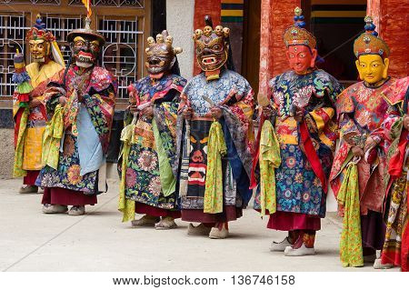 LAMAYURU INDIA - JUNE 13 2015: Unidentified buddhist lamas dressed in mystical mask dancing Tsam mystery dance in time of Yuru Kabgyat Buddhist festival at Lamayuru Gompa Ladakh North India