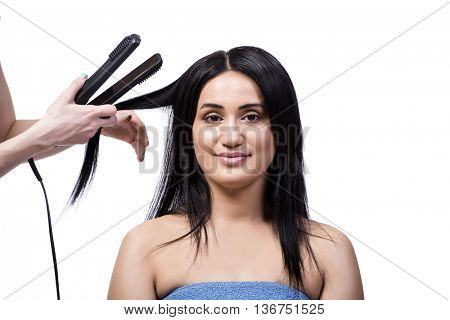 Young woman getting hair straightner isolated on white