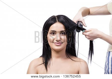 Young woman getting hair straightner isolated on white