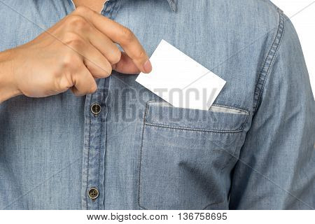 Man with jean shirt taking a blank business card with copyspace from his chest pocket isolated on white background with clipping path.
