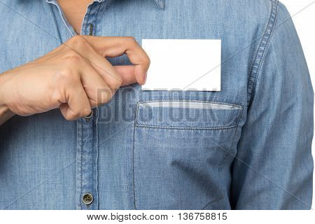 Man with jean shirt holding a blank business card with copyspace from his chest pocket isolated on white background with clipping path.