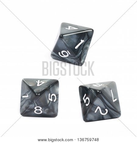 Roleplaying black polyhedral octahedron gaming plastic dice isolated over the white background, set of three different foreshortenings
