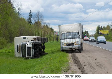 LENINGRAD REGION, RUSSIA - MAY 17, 2015: Overturned truck GAZ-3309 lies on the side of the road