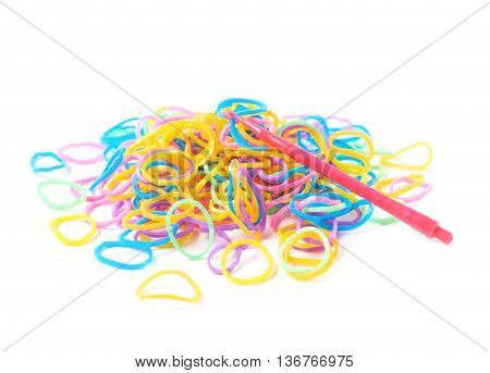 Pile of multiple colorful rubber toy loom bands isolated over the white background