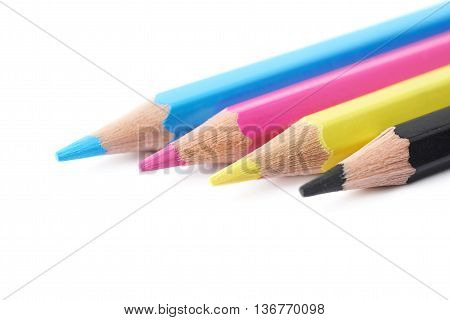 Four cmyk colored drawing pencils composition isolated over the white background, close-up crop