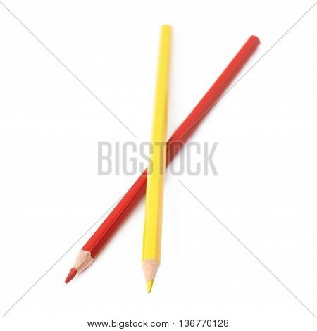 Two red and yellow colored drawing pencils composition isolated over the white background