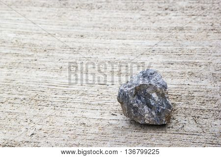 Small gray stone color on a concrete