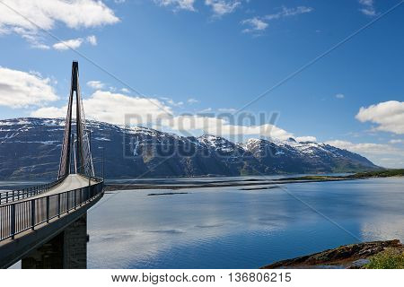 View of Helgeland Bridge and the seven sisters mountain range in Sandnessjøen Norway.