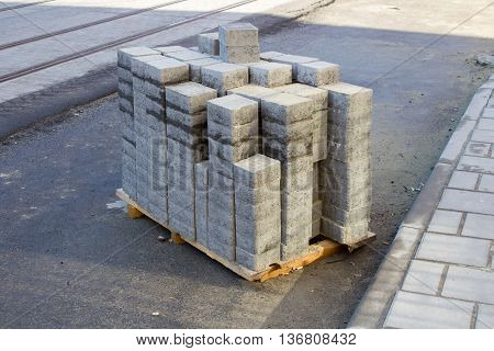 On the wooden pallet new concrete square paving slabs