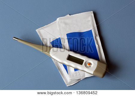 thermometer and sterile gauze two bags of drugs