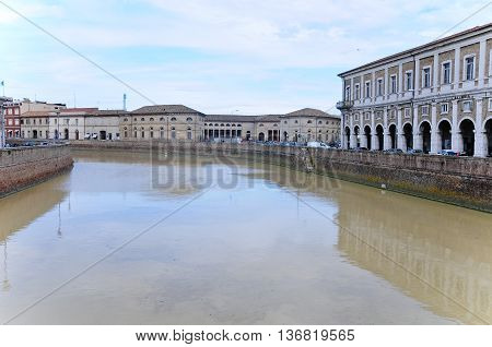 beautiful riverfront seen from a bridge in the city of senigallia