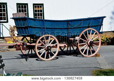 Lancaster Pennsylvania - October 18 2015: Wooden Amish farm wagon with large wheels at the Amish Farm and House Museum