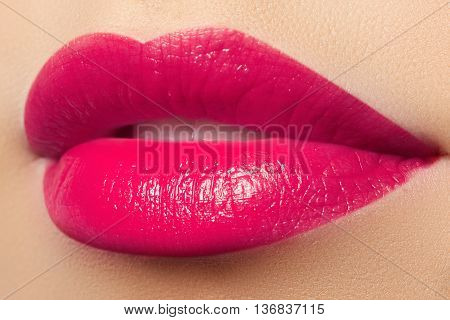 Perfect smile. Beautiful full pink lips. Pink lipstick. Gloss lips. Make-up and cosmetics