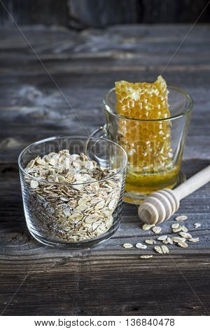 Ingredients for breakfast cereals, milk honeycomb on a dark wooden background