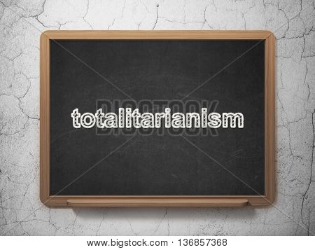 Political concept: text Totalitarianism on Black chalkboard on grunge wall background, 3D rendering