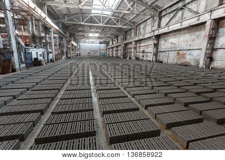 Stack of bricks. Manufacturing of aerated concrete blocks. Manufacturing of cinder block. The plant manufactures building material. The plant produces a cinder block. Cinder block-building material.
