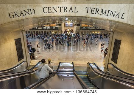 New York, USA - June 19, 2016: Bustling grand central terminal in New York City with sign and view from escalator